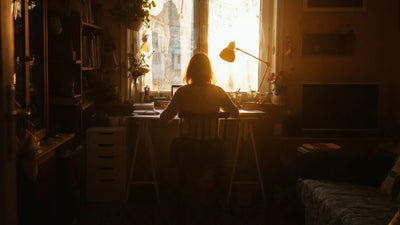 A woman working at a desk in a small living room
