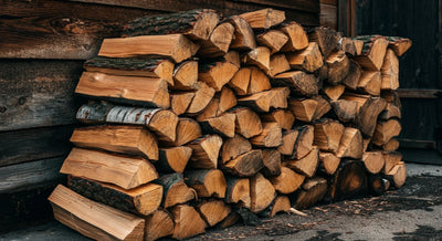 Neatly stacked firewood outdoors, prepared for winter heating or seasonal home use.